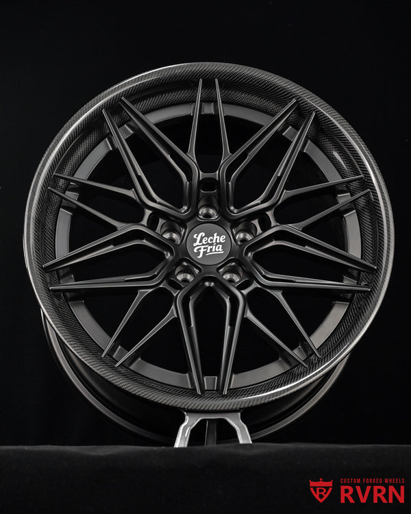 RV-C081 multi-spoke carbon fiber-look forged wheel in a matte black finish for 2022 Tesla , featuring a central 'Leche Fria' logo and an 'RVRN' watermark in the bottom right corner, set against a solid black background.