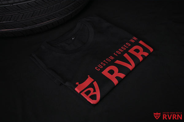 Black RVRN T-shirt with red Custom Forged Wheels logo displayed beside performance tires.