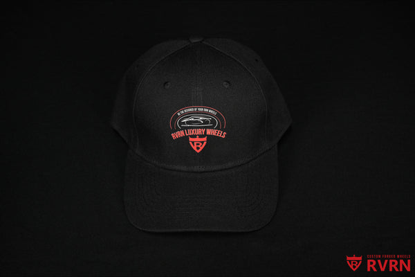 Front view of the black RVRN Custom Forged Wheels baseball cap with red and white RVRN Luxury Wheels graphic.