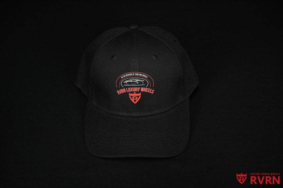 Front view of the black RVRN Custom Forged Wheels baseball cap with red and white RVRN Luxury Wheels graphic.