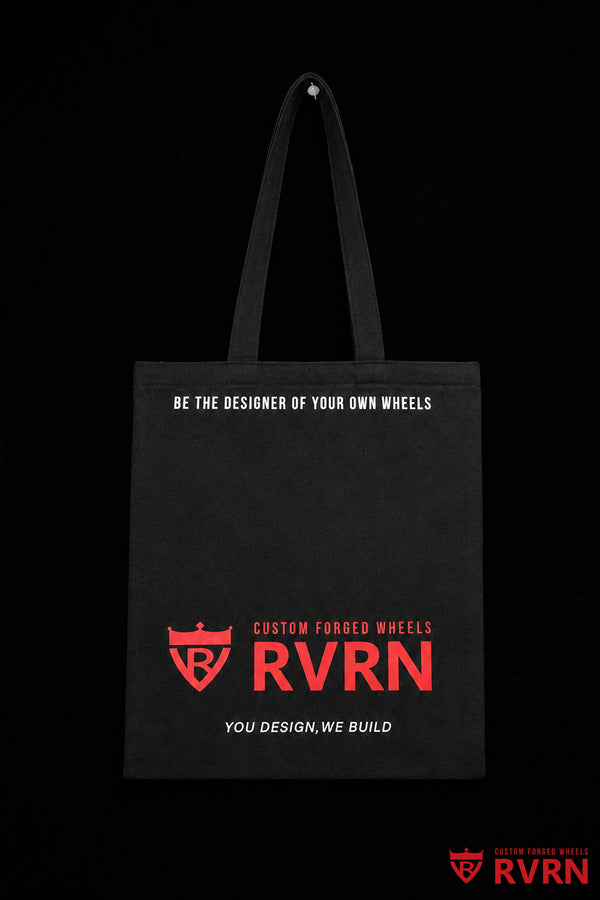 Reverse of the black RVRN Custom Forged Wheels canvas tote bag with red wordmark and white brand slogans.