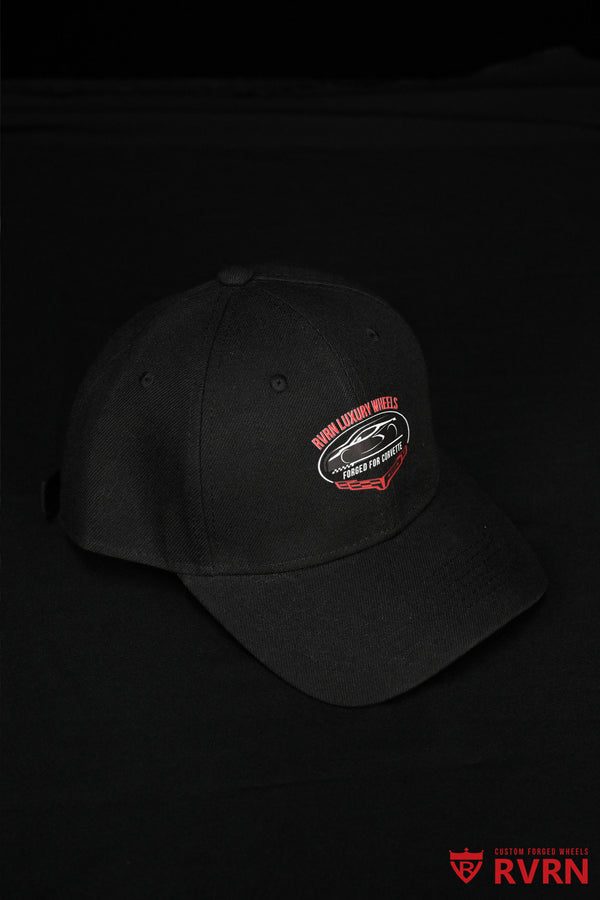 Angled portrait view of the black RVRN Custom Forged Wheels Corvette baseball cap with red and white Forged for Corvette graphic.