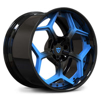 Corvette C8 Rapid Blue custom wheels, RVRN RV-DC491 gloss black to rapid blue gradient face with gloss black barrel concave split 5-spoke angled view.