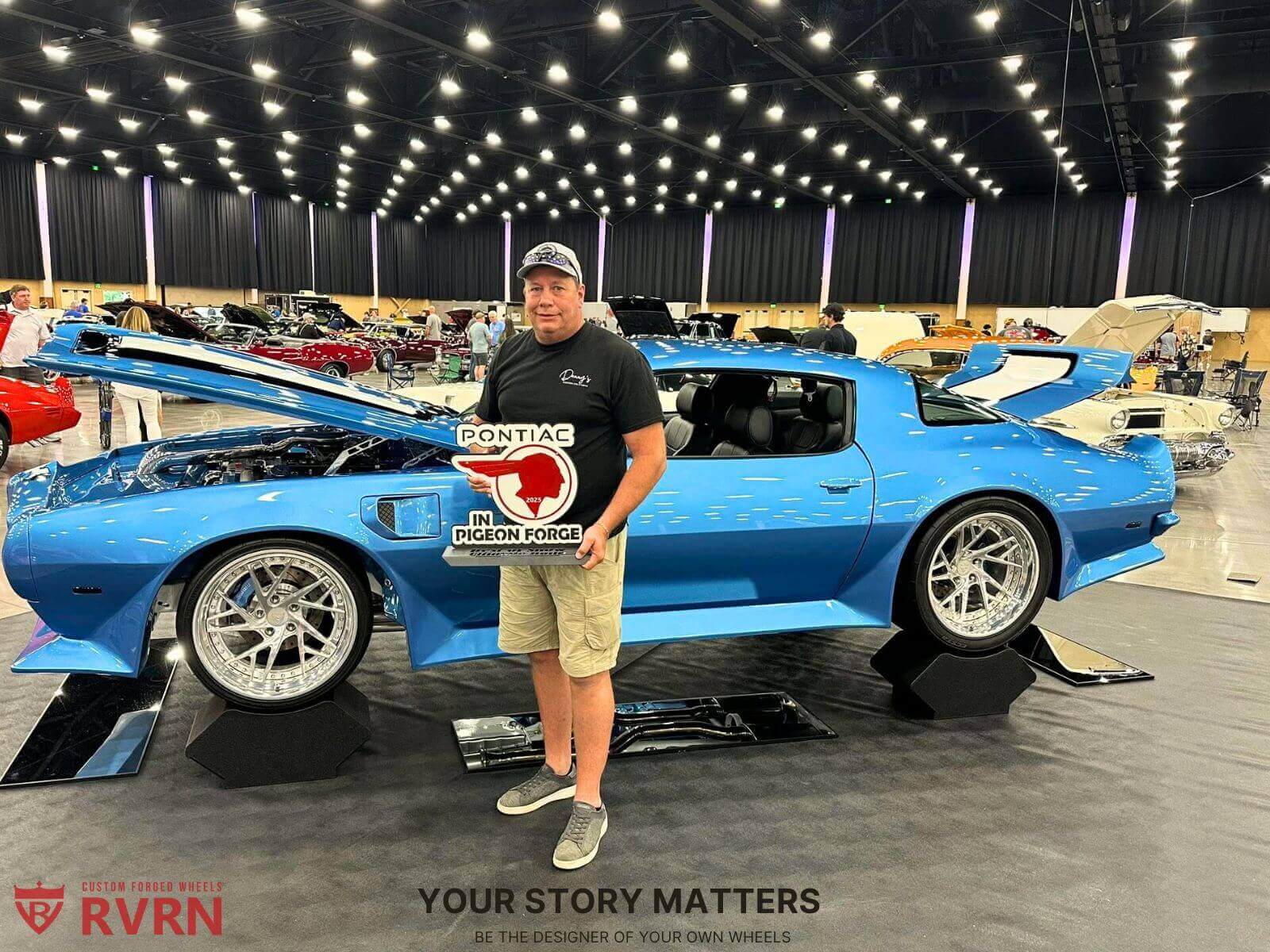 RVRN customer at a car show showcasing custom forged wheels on a blue Pontiac, design your own wheels experience.