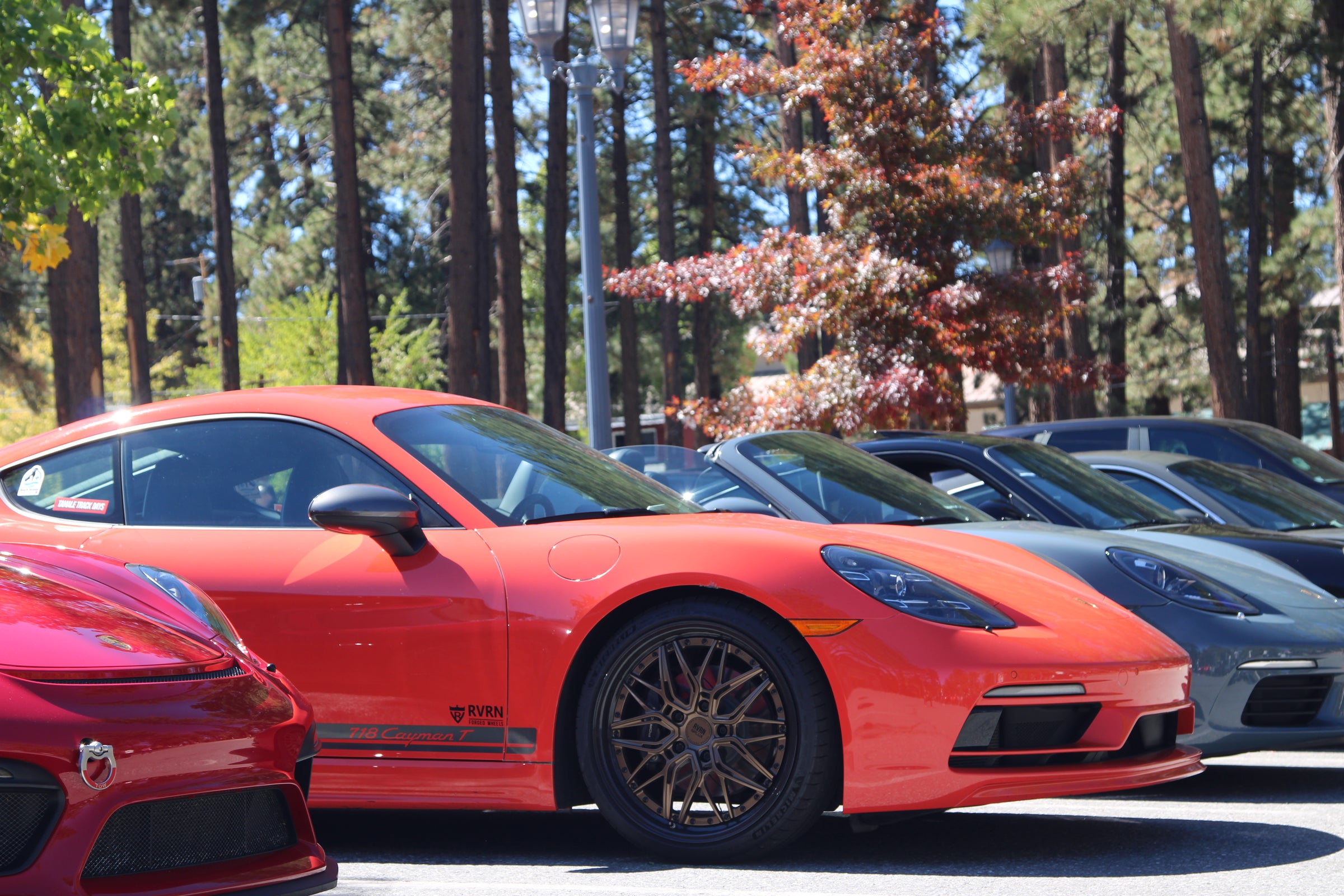 Display area featuring Porsche models and RVRN forged wheels.