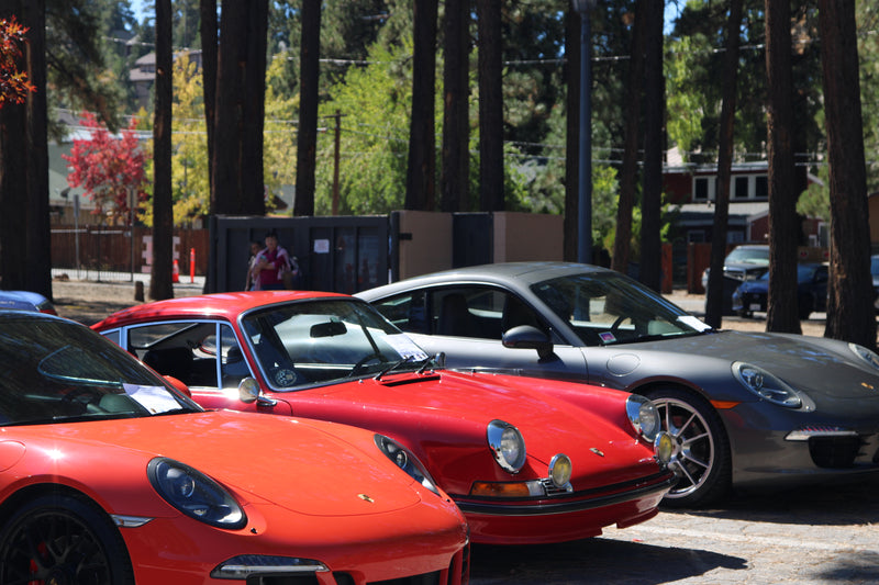 Outdoor scene of the Porsche Timeline car show under cloudy weather.