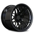 Custom forged concave carbon fiber wheel design, showcasing a sleek black finish and intricate detailing for style and performance.