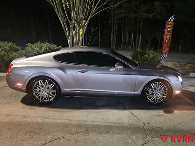 2006 Bentley Continental GT with custom forged RVRN deep dish wheels, showcased at night in a striking silver finish.