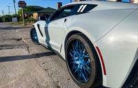 Corvette ZR1 with custom polished blue forged wheels and carbon fiber lip on a street.