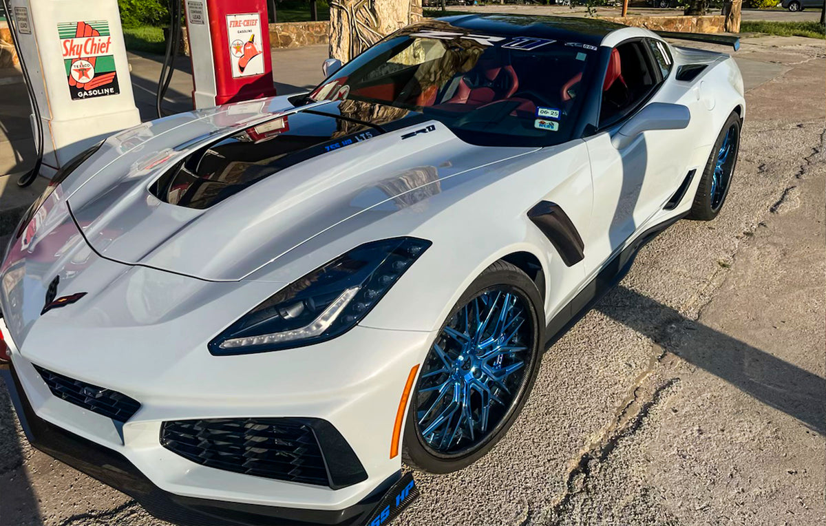Custom Corvette ZR1 with polished blue forged wheels and carbon fiber lip, featuring the ZTK track package.
