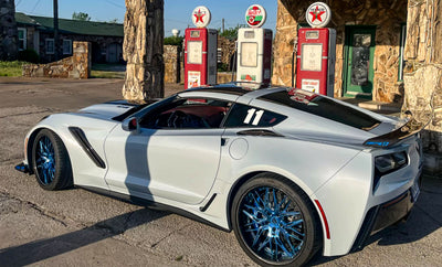 White Corvette C7 ZR1 showcasing RVRN forged polished blue wheels with carbon fiber lip and ZTK track package.