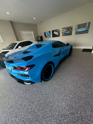 2025 Corvette Z06 in Rapid Blue with RVRN forged wheels and deep concave design, showcased in a stylish garage.