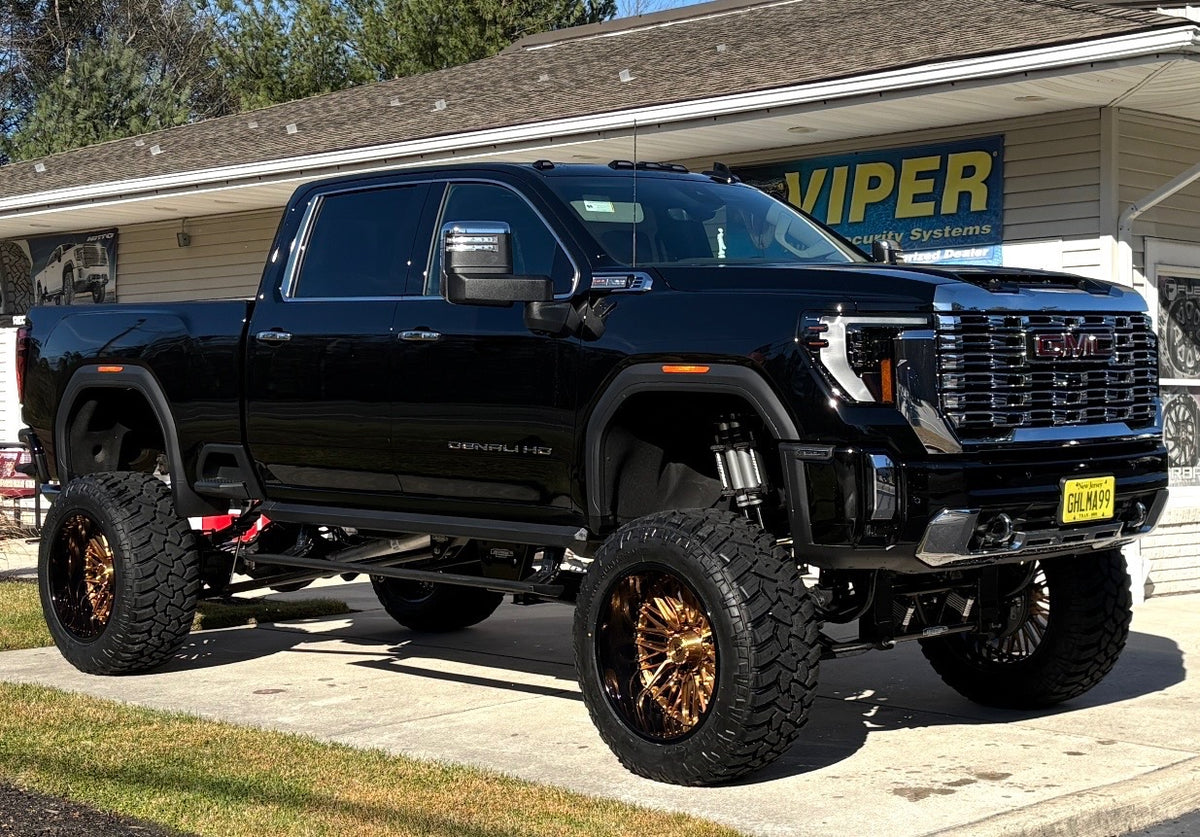 2025 GMC Denali 2500HD on RVRN T081 24x14 Copper Black 8-lug deep-dish forged wheels – front angle view