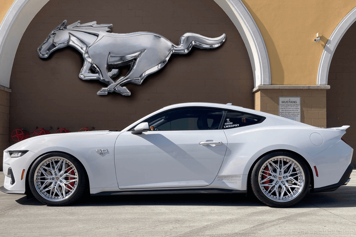 Full side view of a white 2024 Ford Mustang GT on RVRN RV-T081 deep dish custom forged wheels with pearl white polished spokes