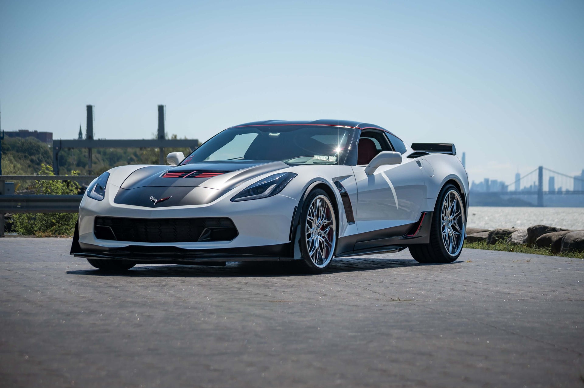 White corvette sports car on a road with a scenic background