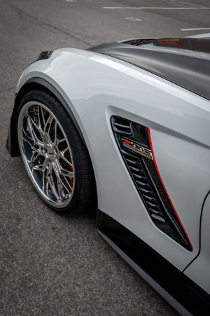 Detailed view of the RVRN RV-T081 polished aluminum wheel on the front fender of a white 2015 Corvette C7 Z06