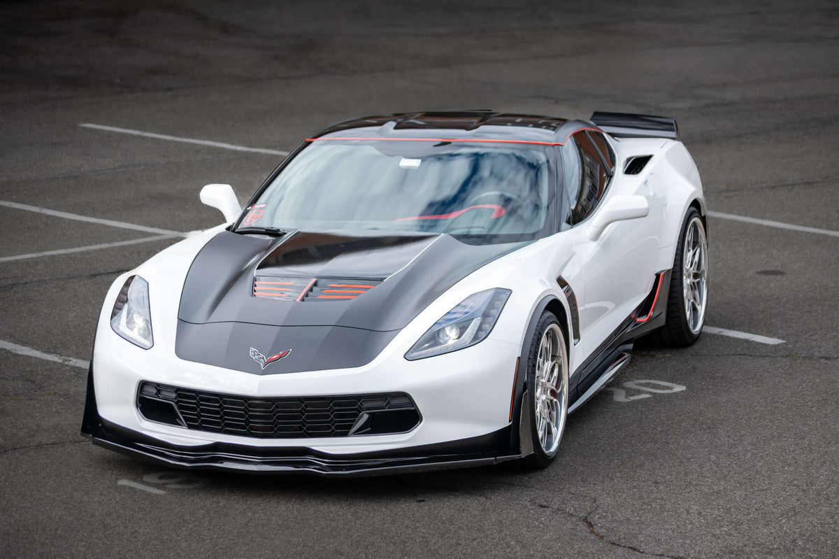 Front three-quarter view of a white 2015 Corvette C7 Z06 on RVRN RV-T081 polished aluminum deep dish wheels in an empty parking lot