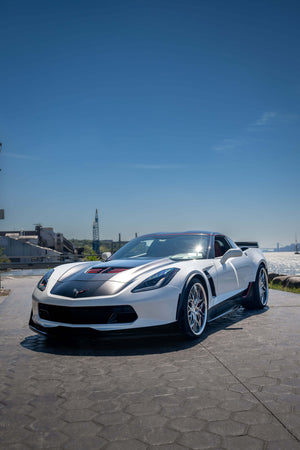 Side view of a white 2015 Corvette C7 Z06 on RVRN RV-T081 polished aluminum deep dish wheels on a waterfront promenade