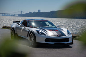 Front three-quarter view of a white 2015 Corvette C7 Z06 on RVRN RV-T081 polished aluminum deep dish wheels by the waterfront