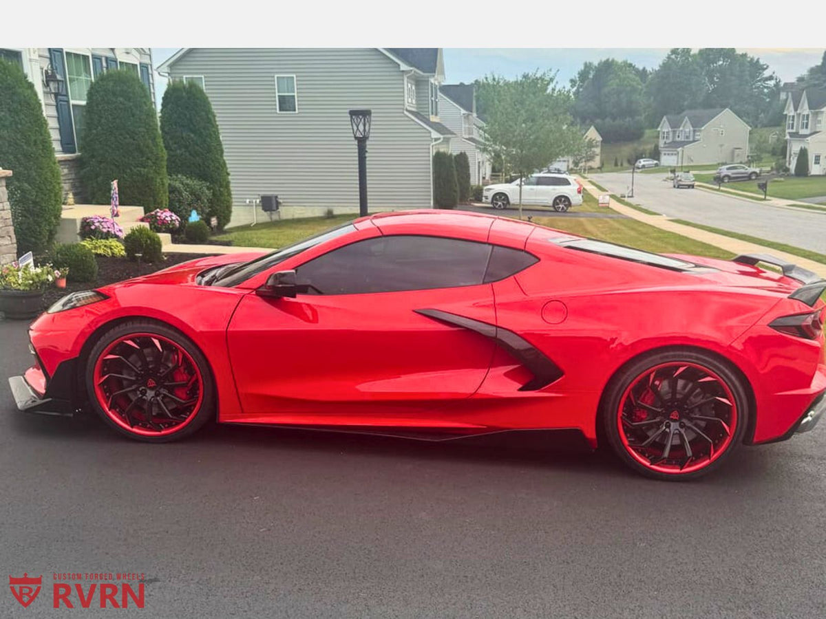 Front quarter view of Torch Red C8 Z51 with RVRN RV-DC01 custom wheels, red-black directional spokes, 20x9 fitment.