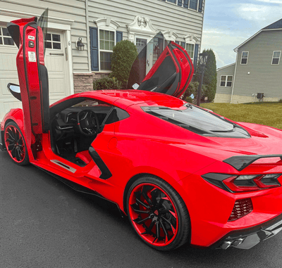 Close-up of RVRN RV-DC01 red-black forged wheel on 2023 Corvette C8 Z51, showing 20x9 +35mm front sizing.
